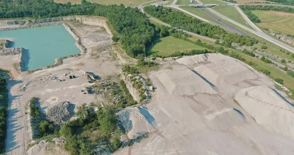 Aerial View in Open Pit Stone Extraction in the Canyon with Deep Green Lake alt
