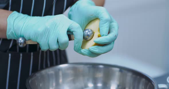 Close Up of Scooping Out Apple Core at Kitchen alt