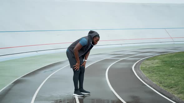 Runner Jumping on Place at stadium.Jogger Warming Before Cardio Workout on Track alt