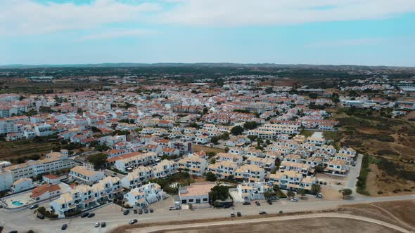 Bird's Eye View Of Vacation Houses At The Coastline Of Altura In Algarve, Portugal In Summer. aerial alt