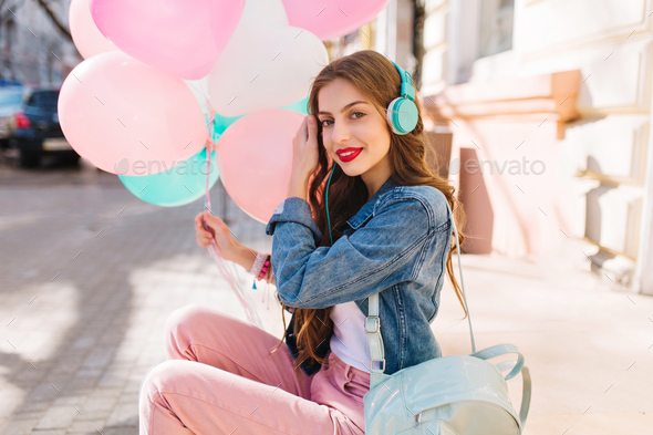 Pretty slim girl in retro outfit listening favourite song in