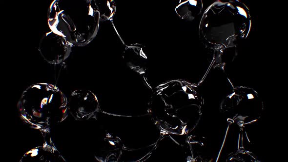 Spheres Of Water Are Separated From Transparent Threads On A Black Background