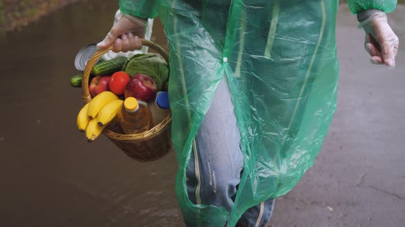 Food Delivery By a Volunteer in Rainy Weather During the Coronavirus Pandemic