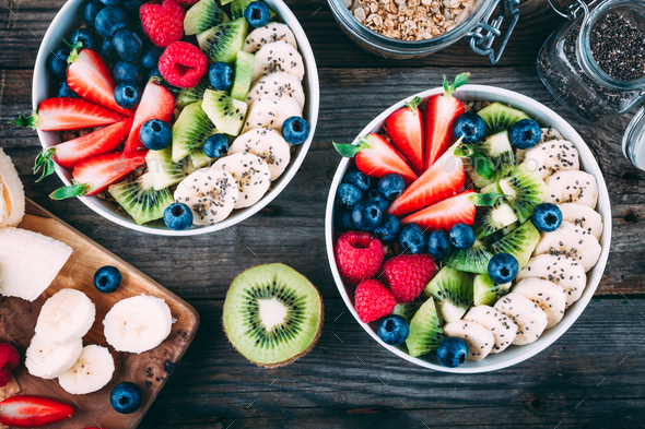 Healthy fresh fruit and berry salad with blueberry, strawberry, kiwi, raspberry, banana - Stock Photo - Images