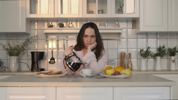 Exhausted Woman Pouring Coffee Early in Morning alt