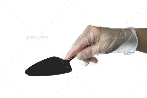 Female hand in disposable glove hold cake spatula, isolated on white background