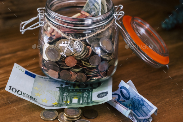 Economy management with coins and cash for next travel destination dream