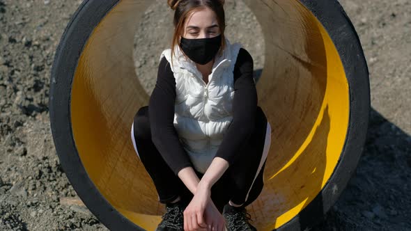 Attractive Masked Woman Sitting Inside. Girl Air Filter Corona Virus Covid-19  alt