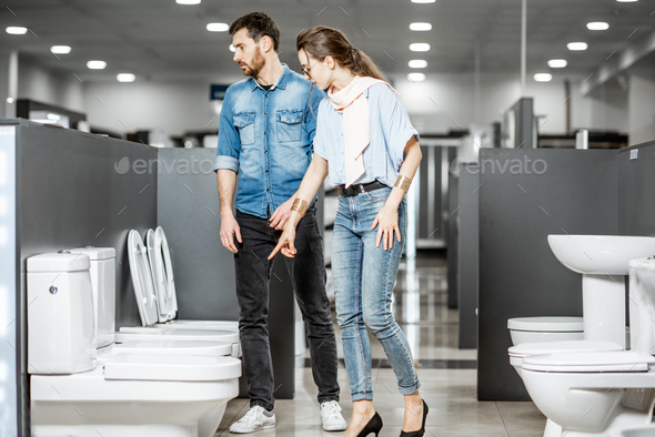 Couple choosing toilet ceramics in the shop