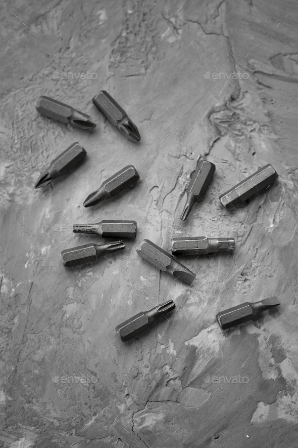 Set of screwdriver bits, concrete background - Stock Photo - Images