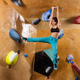 Caucasian young woman bouldering in indoor climbing gym - PhotoDune Item for Sale