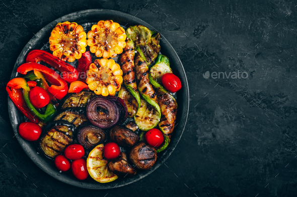 Grilled vegetables in bowl on dark stone background, top view. - Stock Photo - Images