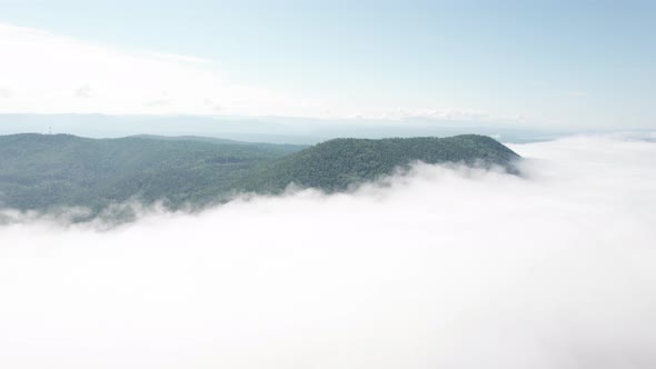Flying Through the Clouds Above Mountain Tops alt