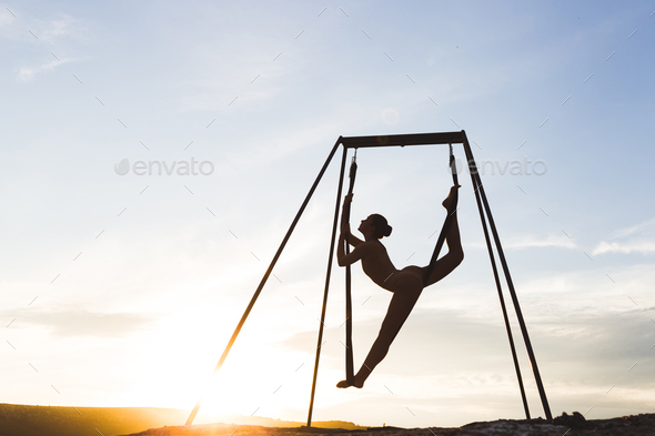 A woman practicing yoga poses outdoor over sunset ocean background Stock  Photo - Alamy