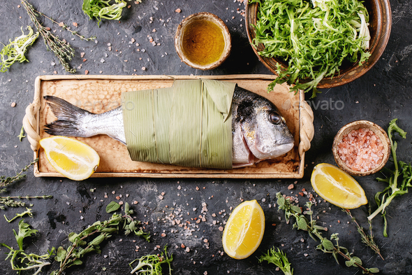 Raw uncooked fresh gutted sea bream or dorado fish - Stock Photo - Images