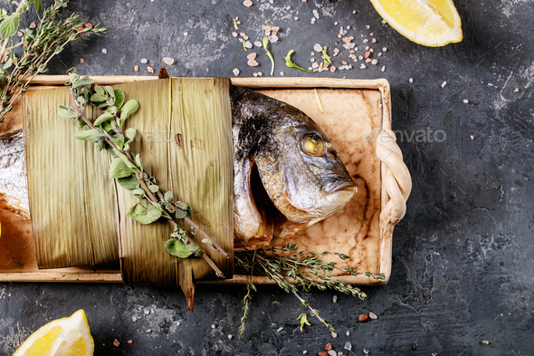 Raw uncooked fresh gutted sea bream or dorado fish - Stock Photo - Images