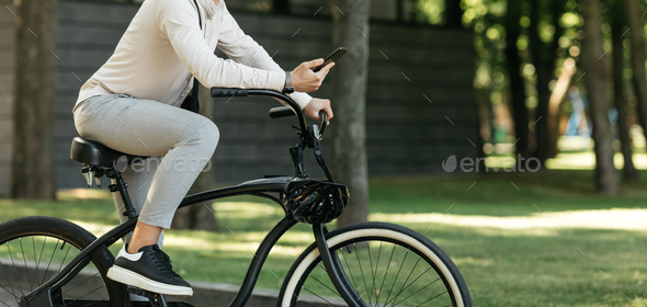 Young stylish businessman going to work by bike, eco transport in city