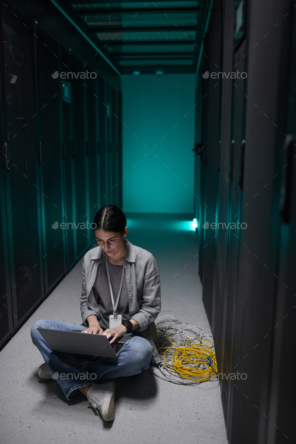 Young Woman Sitting on Floor in Server Room