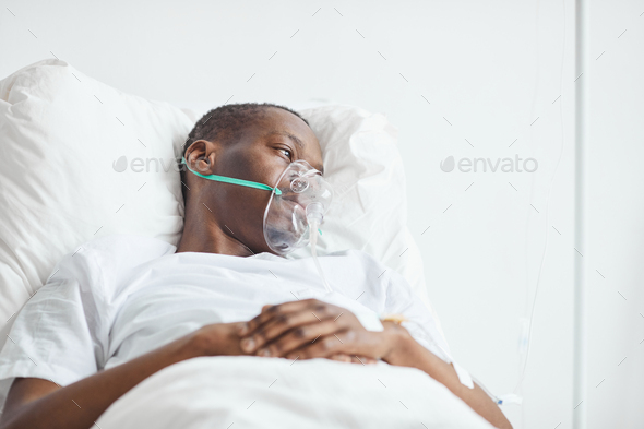 Man with Oxygen Support Mask in Hospital