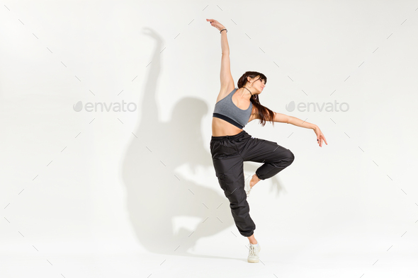 Graceful young woman dancer performing a classic dance pose