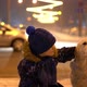 Love for Pets. Little Boy Stroking His Dog Outdoors in Winter in the Evening City - VideoHive Item for Sale