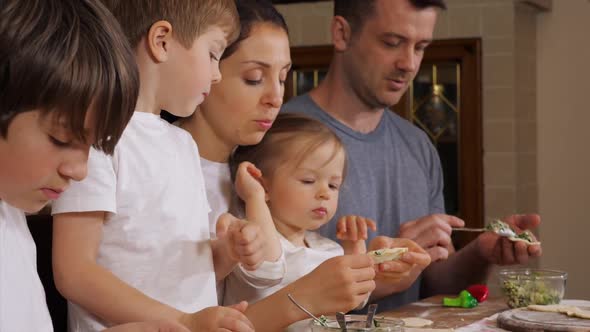 Children with Parents Is Preparing Dumplings in Domestic Kitchen