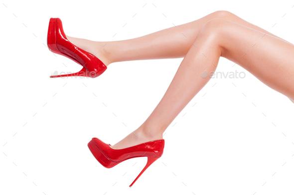 Cheeky heel. Close-up of young woman in high heeled shoes isolated on white