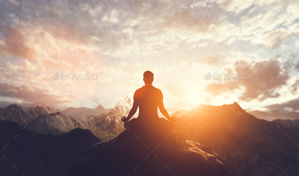 Man in yoga pose, zen meditation at sunset. Stock Photo by photocreo
