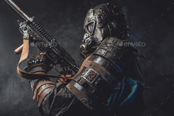 Grimy hunter with gas mask and custom gun in dark background