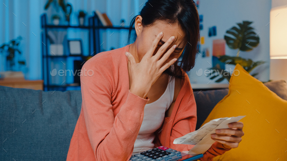 lady feel stress and worried with bill and invoice credit card calculating loan on sofa. - Stock Photo - Images