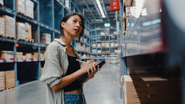 woman manager looking for goods using digital tablet checking inventory. - Stock Photo - Images