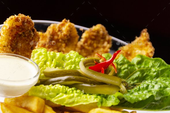 Chicken tenderloin with French fries and lettuce