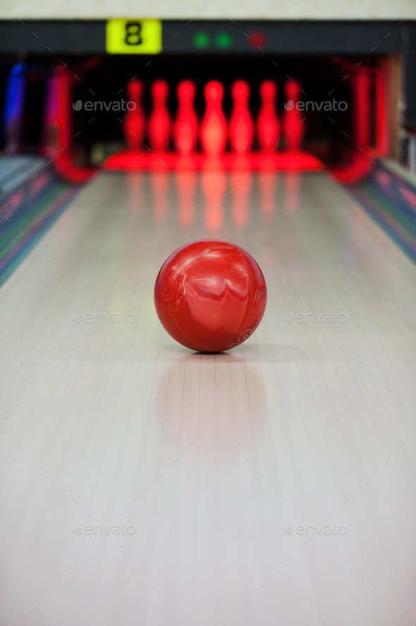 Moment when the heart stops beating. Close-up of bright red bowling ball rolling along bowling alley