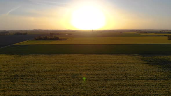 Drone flying towards horizon and upwards. Lonely windmill spinning prt-one alt