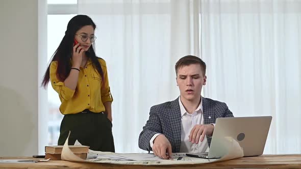 team of professional designers works in a bright office alt