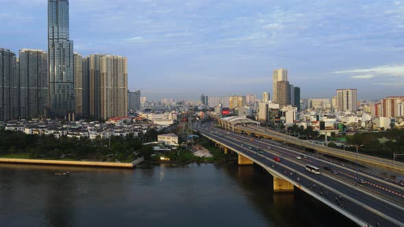 Aerial view of traffic on the QL52 highway, golden hour in Ho chi minh, Vietnam - low, tracking, dro alt