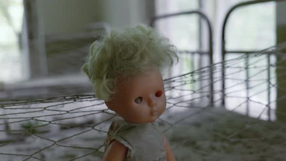 Old Doll Inside The Abandoned KIndergarten In Pripyat, A Town Close Chernobyl, Ukraine - Closeup sho alt