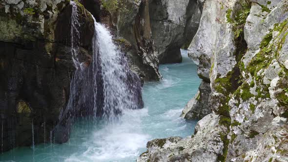 Small waterfall pouring into the Soca River alt