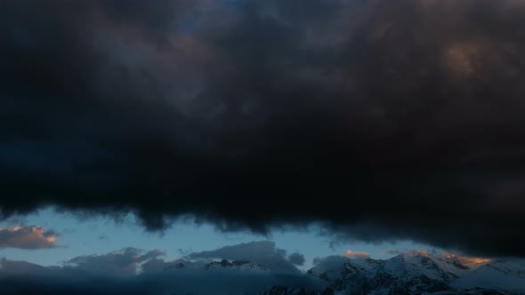 Clouds Over Winter Snowy Mountains alt