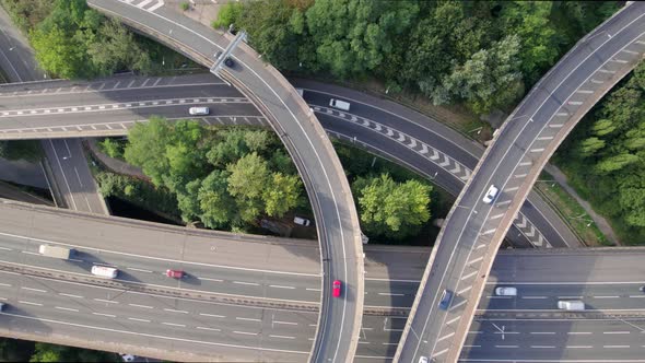 Vehicles Driving Through a Mixing Bowl Interchange Aerial View alt
