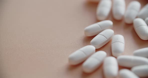 Scattered Pile Of White Tablets Pink Background