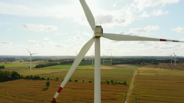 Drone Shot at Wind Turbines at a Large Wind Farm in a Field During Sunset alt