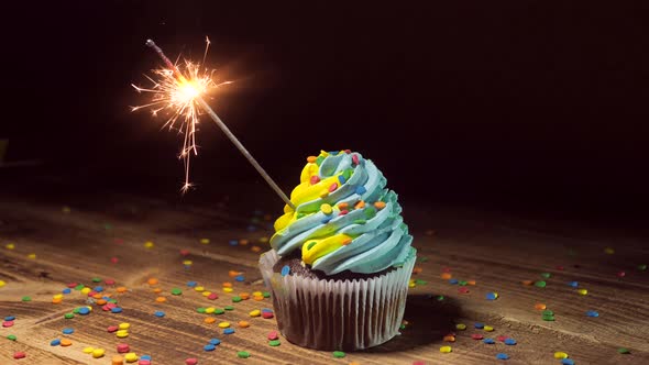 Delicious Cupcake with Blueyellow Cream Icing alt