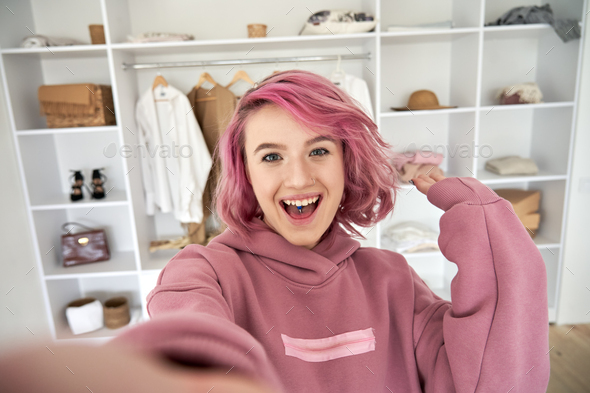 Excited hipster gen z teen girl fashion blogger with pink hair recording  vlog. Stock Photo by insta_photos