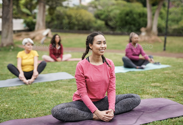Yoga. Girl doing exercises in the park. Stock Photo by