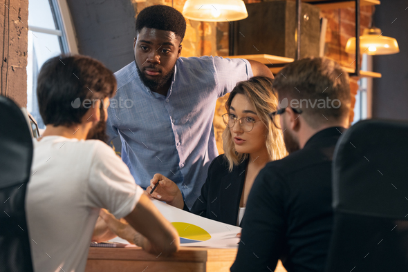 Colleagues working together in modern office using devices and gadgets during creative meeting - Stock Photo - Images