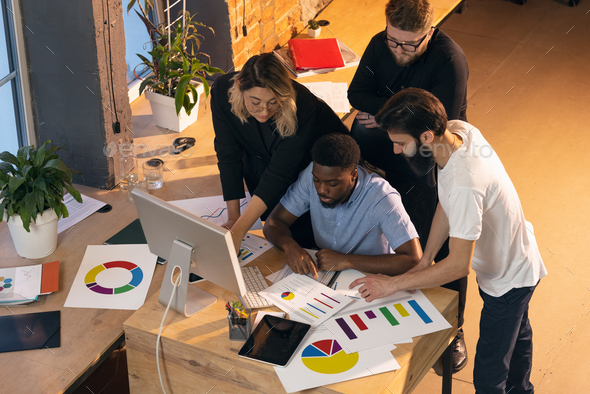 Colleagues working together in modern office using devices and gadgets during creative meeting - Stock Photo - Images