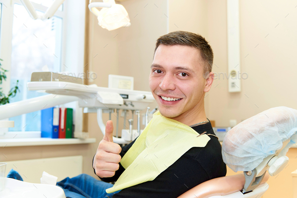 Happy patient at the dental office - Stock Photo - Images