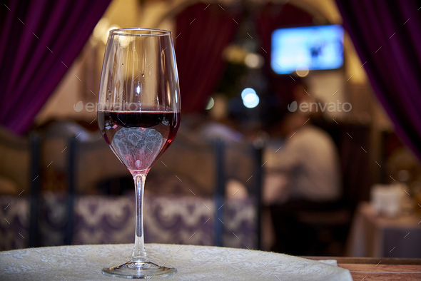 Glass of red wine in a restaurant - Stock Photo - Images