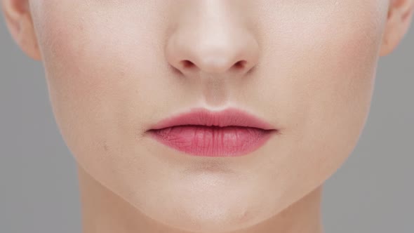 Studio portrait of young, beautiful and natural woman over grey background. alt